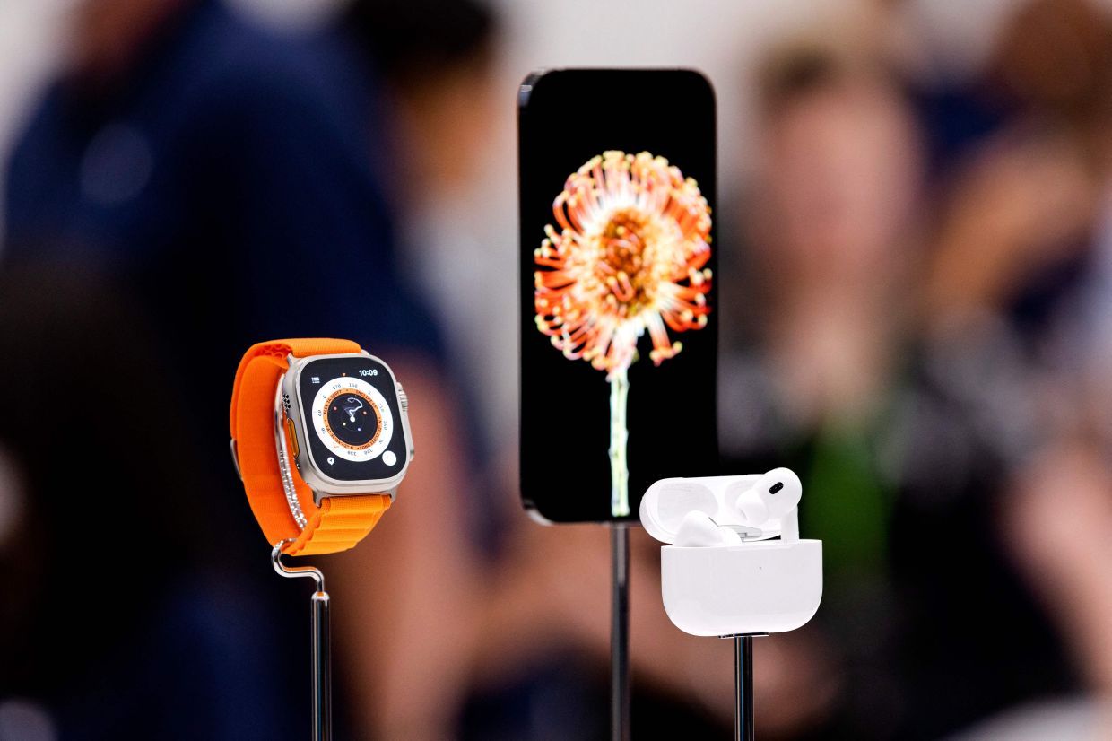 One of the newly released iPhones is displayed alongside the new Apple Watch Ultra and AirPod Pros during a launch event for new products at Apple Park in Cupertino, California, on September 7, 2022. - Apple unveiled several new products including a new iPhone 14 and 14 Pro, three Apple watches, and new AirPod Pros during the event. (Photo by Brittany Hosea-Small / AFP)