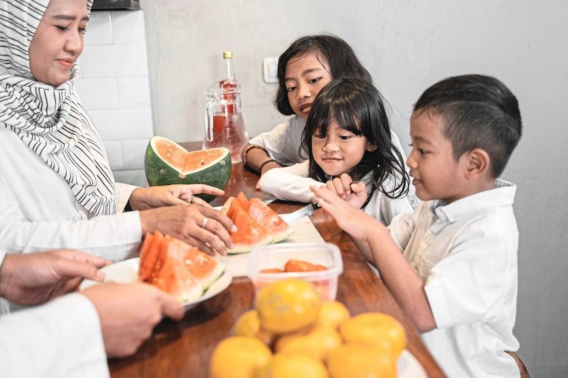 kids help their muslim parent preparing for break fasting dinner