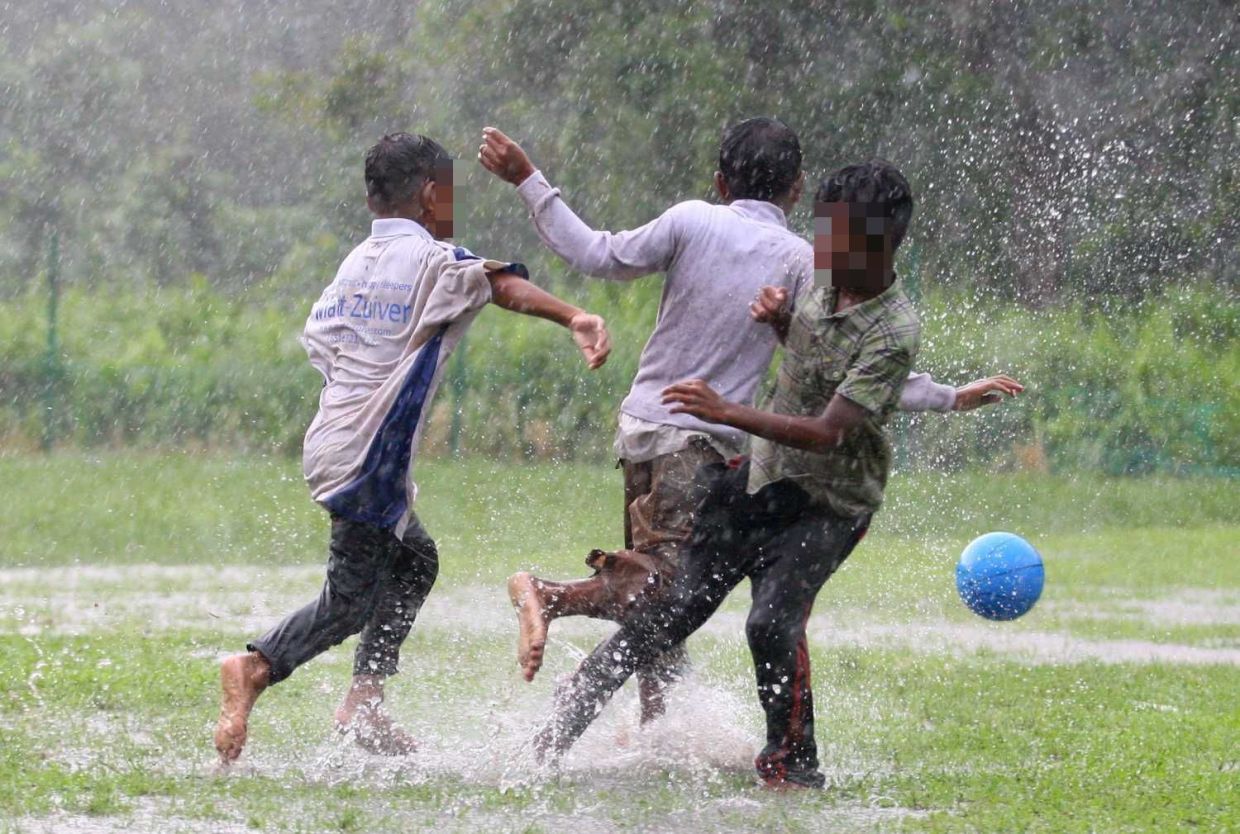 Orang Asli kids having a fun filled time playing football in the rain especially during the year end school holidays. The kids from Kampung Simpang Arang, Gelang Patah play almost daily whether rain or shine.