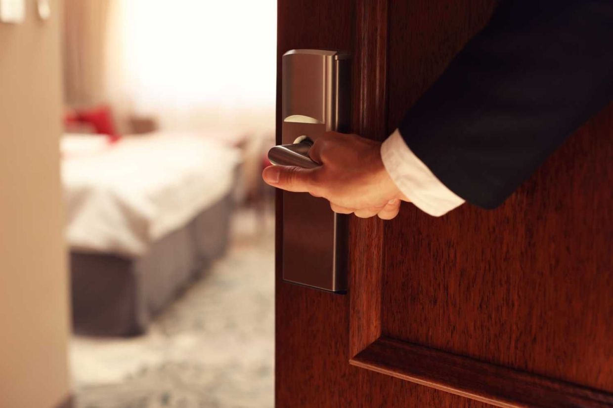Picture showing hand of businessman opening hotel room