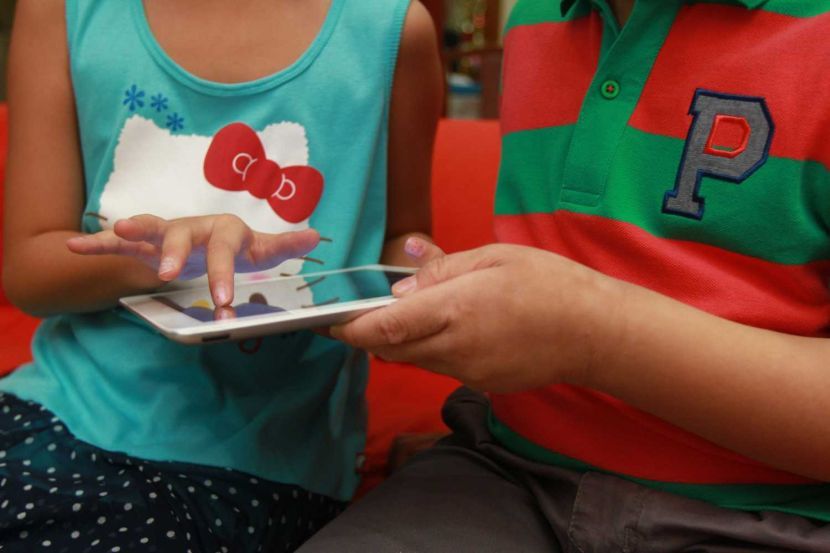 Children looking for porn sites on tablet.