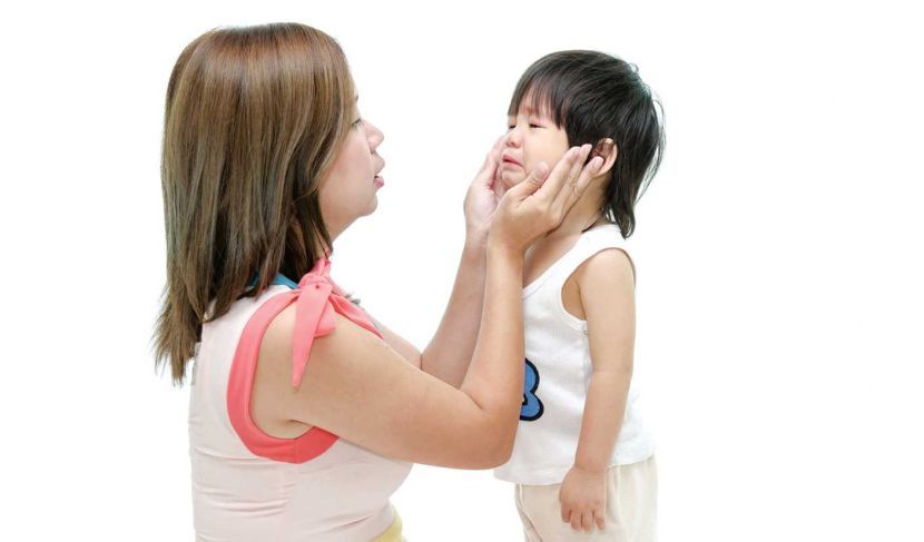 Mother and asian baby crying