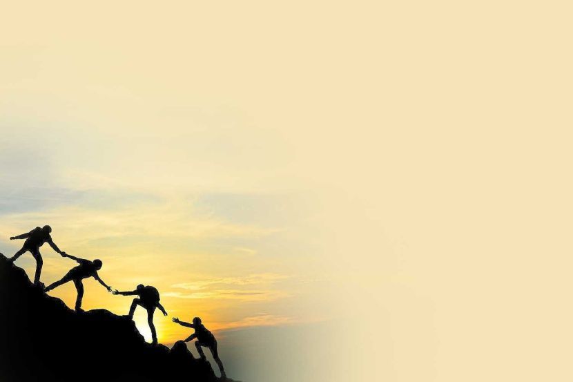 Group of people on peak mountain climbing helping team work with sunset background , travel trekking success business concept