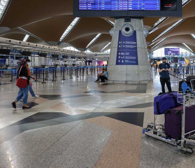 Travelers at the Kuala Lumpur International Airport, March 29, 2022. Malaysia will reopen its borders to international travellers starting April 1. — GLENN GUAN/The Star