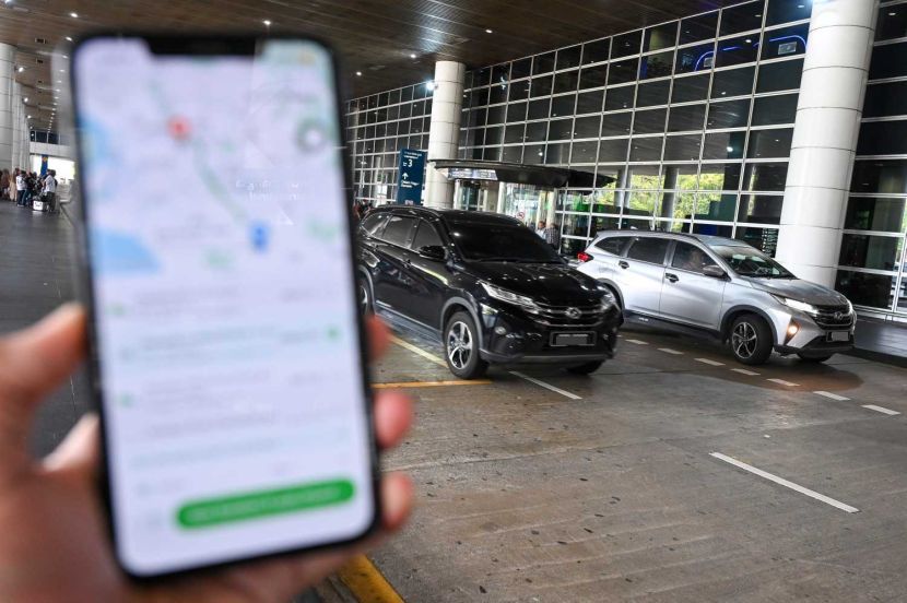Perodua Aruz e-hailing drivers on the background at KLIA. Story on drivers have been expressing concerns that SUVs are no longer able to register for e-hailing use. — IZZRAFIQ ALIAS/The Star