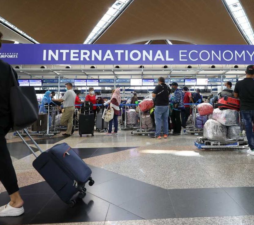 Travelers at the Kuala Lumpur International Airport, March 29, 2022. Malaysia will reopen its borders to international travellers starting April 1. — GLENN GUAN/The Star