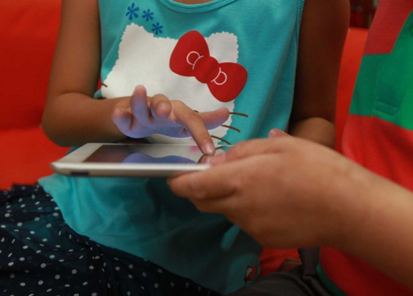 Children looking for porn sites on tablet.