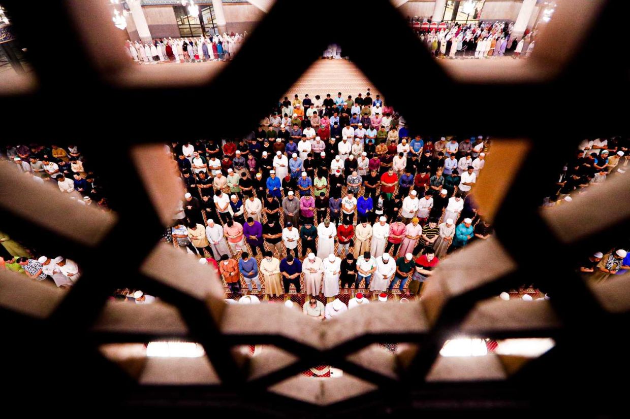 United in prayer: Muslim taking part in evening mass prayers known as ‘Terawih’ to welcome the holy fasting month of Ramadan at the The National Mosquein Kuala Lumpur. — MUHAMAD SHAHRIL ROSLI/The Star