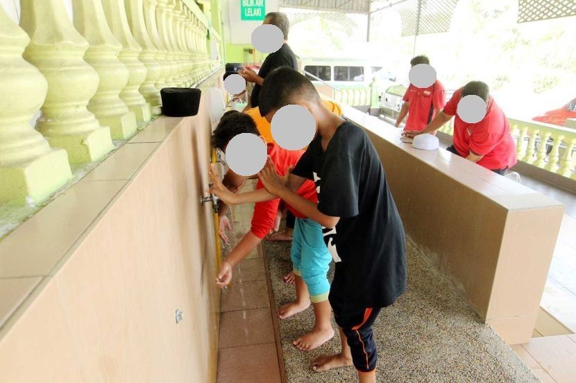 Life is normal.....Children wash their hand before having afternoon praying at Pasir Puteh Mosque. - Art Chen/ The Star.