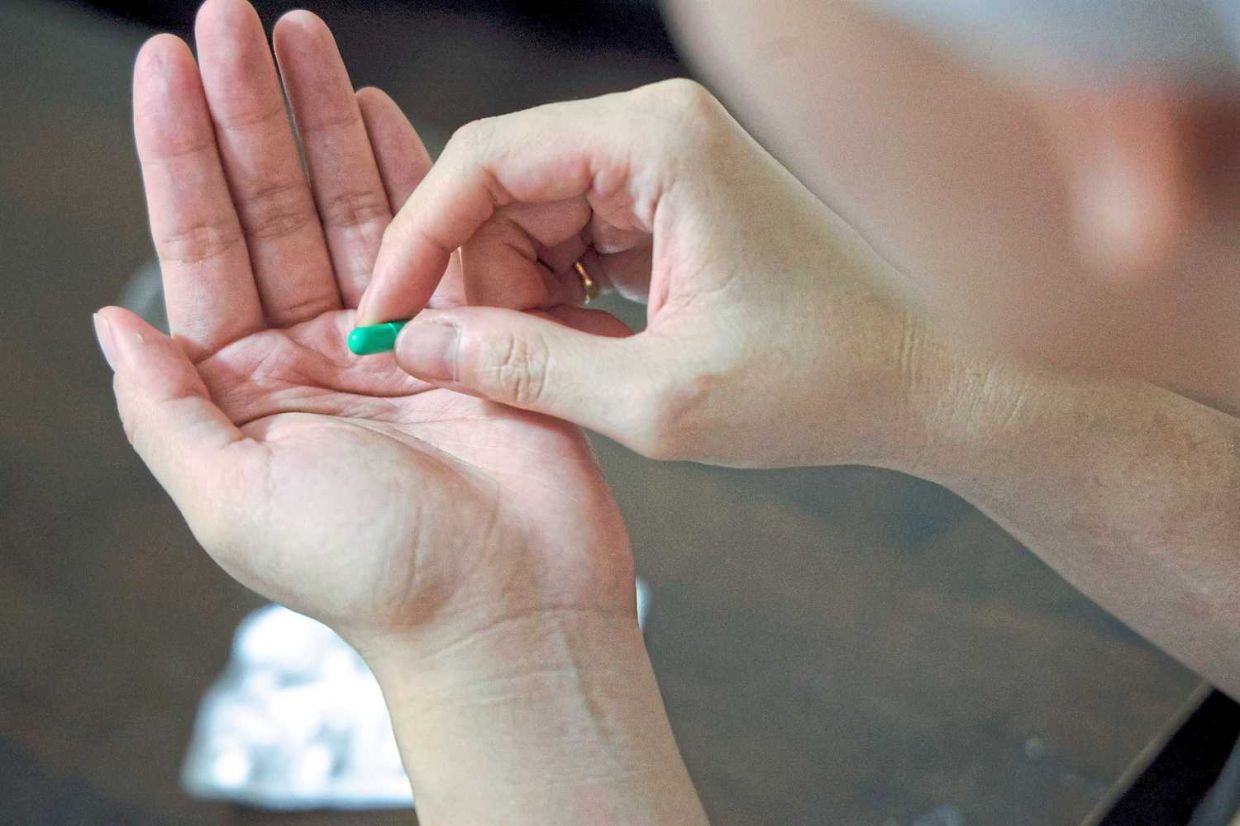 posing pic of ppl taking antibiotic tablet. (SEPT 4 2023) — ART CHEN/The Star